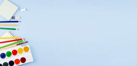 A lot of school supplies on a blue background. Photo banner. Place for your text. Education concept.の写真素材