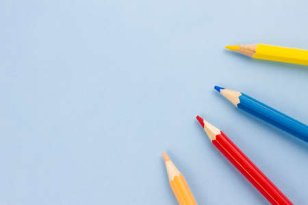 Colored pencils on a blue background. Place for your text. View from above. Education concept.の写真素材