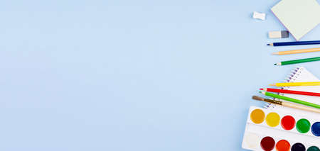 A lot of school supplies on a blue background. Photo banner. Place for your text. Education concept.の写真素材