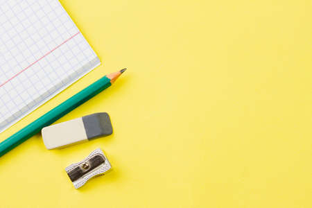 Blank notebook with a pencil on a yellow background. Place for your text. View from above. Education concept.の写真素材