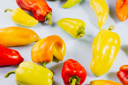 Group of ripe multicolored sweet peppers on gray background, food background, ripe vegetables conceptの写真素材