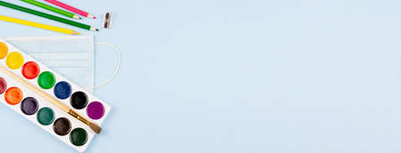 Various bright school supplies on a blue background. View from above. Place for text. Photo banner. Education concept. Epidemic.の写真素材