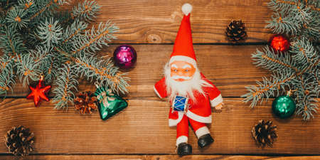 Merry Christmas. Christmas composition with holiday decorations on a wooden background. Christmas or New Year card. Background. Christmas symbol. Happy Holidays. photo bannerの写真素材