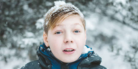 Young man in winter clothes walking, Portrait of a Happy guy photo banner with copy space. Leisure, sport and people conceptの写真素材