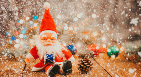 Christmas background with gift boxes, santa claus toy on wooden background with garland bokeh. Festive winter concept. Flat lay, copy space. photo bannerの写真素材