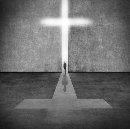 Silhouette of a person before a symbol of faith の写真素材