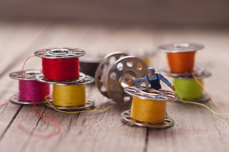 Small worker prepares the material for sewing. Tailoring concept.の写真素材