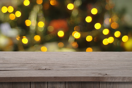 Christmas holiday or party background with empty wooden deck table over festive bokeh. Ready for...