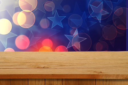 Christmas holiday or party background with empty wooden deck table over festive bokeh. Ready for product montageの写真素材
