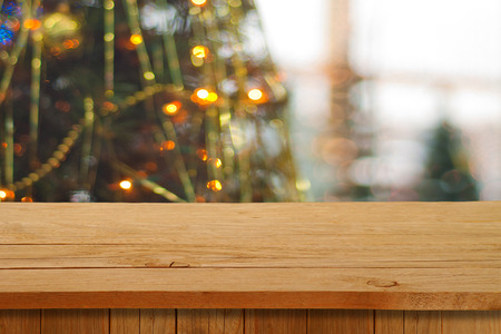 Christmas holiday or party background with empty wooden deck table over festive bokeh. Ready for product montageの写真素材