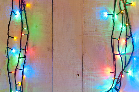 christmas light background over wood planks.