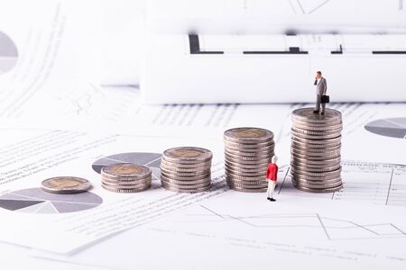 Money, Financial, Retirement, Business Growth concept, businessman miniature mini figures toy stand on top of stack of coinsの写真素材