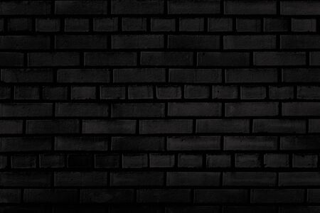 Old dark brick wall texture for background の写真素材