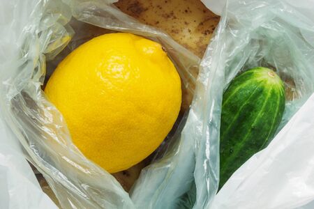 Fruits and vegetables in plastic bags. Pollution danger, ban single-use plastic, plastic free, zero...