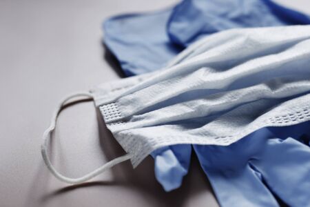 Protective medical face mask and latex gloves. Personal protective equipment shortage concept. Coronavirus, covid 19 preventionの写真素材