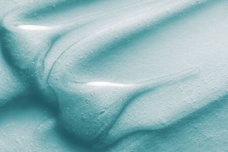 Cosmetic liquid cream soap, shower gel, cleanser, shampoo, conditioner texture. Light blue cosmetic product smear smudge backgroundの写真素材