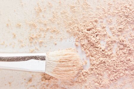 Makeup powder and white cosmetic brush. Light nude color matte foundation powder textureの写真素材