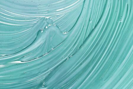 Cosmetic gel texture. Blue transparent skincare product smudged background
