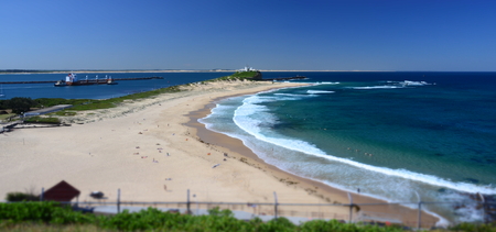 Beach at Newcastle. Nobbley's Lighthouse in the background.の写真素材