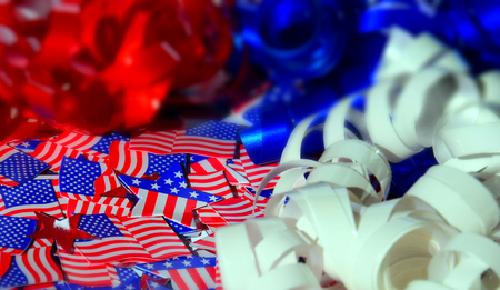Happy Independence Day celebration and patriotism holidays concept - close up of glazed muffins or cupcakes decorated with American flags at 4th of july partyの写真素材