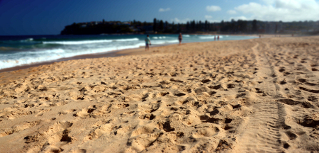 Sandy beach with sea and people on blur backgroundの写真素材