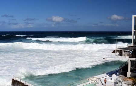 Sydney, Australia - Oct 23, 2016 Bondi Iceberg's swimming pools with ocean view at high tide. Big tide at the beach Bondi Icebergs Club waves fill the pool.のeditorial素材