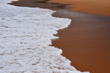 Wave and sand beach for background. Beautiful beach surface texture. Sea wave on sand beach digital illustration. Oceanic water tide on seashore.の写真素材