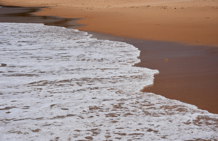 Wave and sand beach for background. Beautiful beach surface texture. Sea wave on sand beach digital illustration. Oceanic water tide on seashore.の写真素材