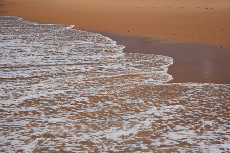 Wave and sand beach for background. Beautiful beach surface texture. Sea wave on sand beach digital illustration. Oceanic water tide on seashore.の写真素材