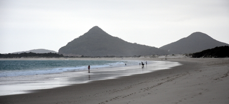 Hawks Nest beach at sunset. Mount Yakaba in the background (Central Coast, NSW, Australia)の写真素材
