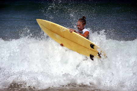 Beautiful surfer woman in bikini enjoying freedom on the beach. Surfing Themed Photo.