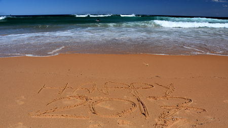 Happy 2017 written on sand at sunset. Happy 2017 lettering on the beach. "Happy 2017" drawn on sand on a beach, closeup shot. Happy 2017  written in sand, on tropical beach.の写真素材
