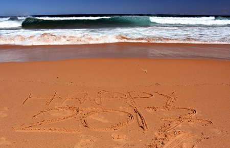 Happy 2017 written on sand at sunset. Happy 2017 lettering on the beach. "Happy 2017" drawn on sand on a beach, closeup shot. Happy 2017  written in sand, on tropical beach.の写真素材