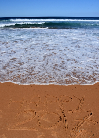 Happy 2017 written on sand at sunset. Happy 2017 lettering on the beach. "Happy 2017" drawn on sand on a beach, closeup shot. Happy 2017  written in sand, on tropical beach.の写真素材