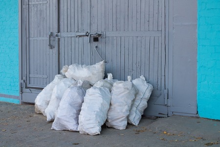 Many bags near the door of a large warehouse.の写真素材
