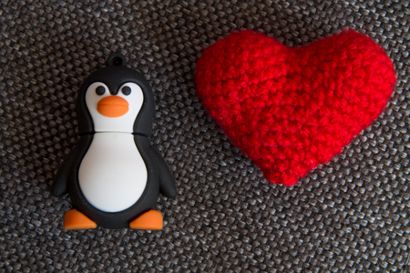 Macro Penguin Toy and Heart at  Textile Background.の写真素材