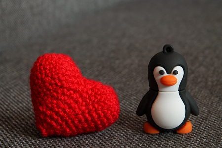 Macro Penguin Toy and Heart at  Textile Background.の写真素材