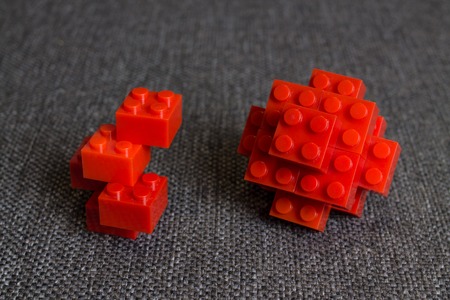 Construction from Red Bricks Elements. at Textile Background.