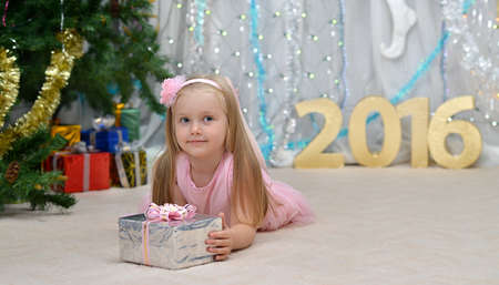 greeting new year card with well-dressed girl and gifts, decorationsの写真素材
