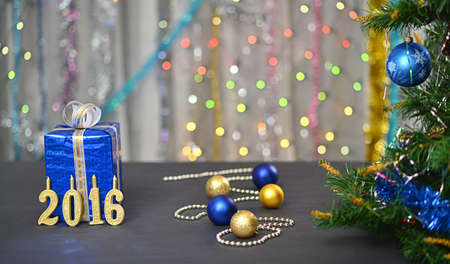 Christmas, new year card 2106 with present, free place for celebration. Fir and garlands. Golden...