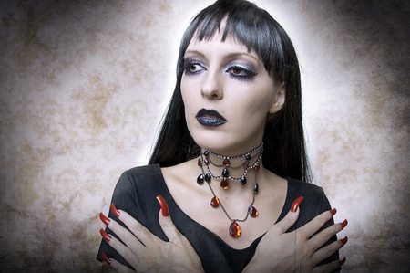 Halloween concept. Fashion portrait of gothic style woman night vampire or evil witchin black dress...