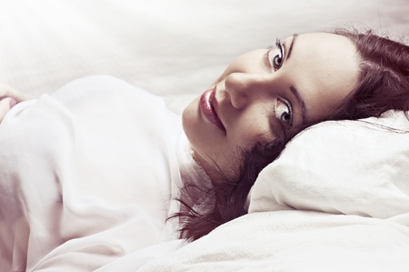 Lovely face of sexy female model in light bedroom in the morning の写真素材