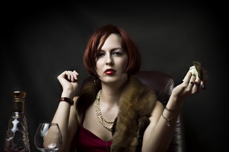 Glamour portrait of sexy woman face with bright evening make up for party and jewelry gold rings with precious stones sitting on the tableの写真素材