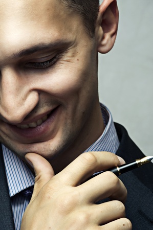 Smiling successful businessman with penの写真素材
