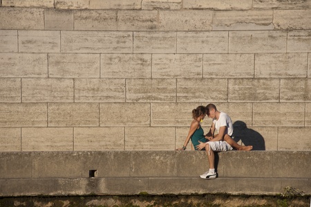 PARIS - SEPTEMBER 29: Young loving couple on bank by the Seine of Paris on September 29, 2011 in Paris.のeditorial素材