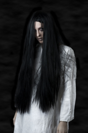 a scary ghost girl wearing a white nightie の写真素材