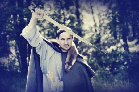 Fantasy portrait of handsome dangerous man with medieval swordの写真素材