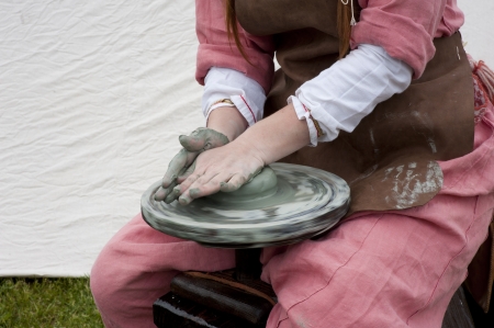 hands of a potter, creating an earthen jar on the circleのeditorial素材