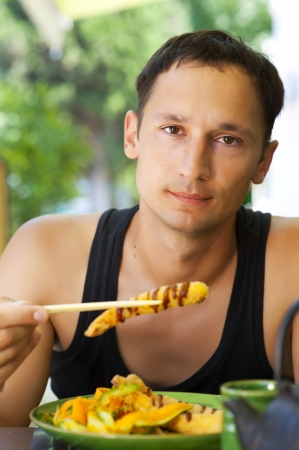Young adult male lunch in the Japanese outdoor restaurantの写真素材