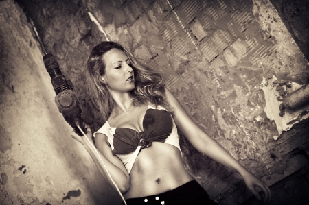 Fashion portrait of Beautiful blond woman with heavy drill in her hands の写真素材